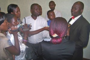 Journalists interviewing CEHURD's programmes coordinator prior to the hearing of the appeal 